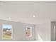 A light and airy bonus room with white walls and two windows offering natural light at 3740 Near Star Ln, Cumming, GA 30028