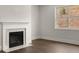 Close up of a fireplace with white mantle and marble surround, next to a window at 3740 Near Star Ln, Cumming, GA 30028