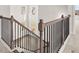 Open staircase with dark wood and iron spindles leads to the upper level of the home at 3740 Near Star Ln, Cumming, GA 30028