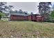 Spacious backyard featuring a red brick home with a covered deck at 1245 Shore Dr, Atlanta, GA 30311