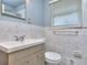 Modern bathroom featuring a marble tile wall, a brushed metal faucet, and a vanity at 1245 Shore Dr, Atlanta, GA 30311
