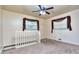 Cozy bedroom featuring a ceiling fan, carpeted floors, and two windows for natural light at 1245 Shore Dr, Atlanta, GA 30311