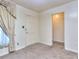 A bedroom featuring a door and a walk-in closet, natural light and neutral carpet at 1245 Shore Dr, Atlanta, GA 30311