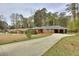 Charming brick ranch with a long driveway and well-manicured lawn at 1245 Shore Dr, Atlanta, GA 30311