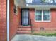 Close-up of the home's front door, brick facade, and adjacent windows at 1245 Shore Dr, Atlanta, GA 30311