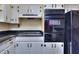 Well-equipped kitchen with black appliances, gas cooktop, and ample cabinet storage at 1245 Shore Dr, Atlanta, GA 30311