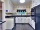 This kitchen boasts white cabinets, black appliances, and black countertops at 1245 Shore Dr, Atlanta, GA 30311