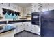 Eat-in kitchen featuring white cabinets, black countertops, and black appliances at 1245 Shore Dr, Atlanta, GA 30311