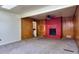 Living room featuring a red brick fireplace, wood paneling, and plush carpeting at 1245 Shore Dr, Atlanta, GA 30311