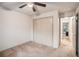 Bedroom featuring neutral carpet, a ceiling fan and a view into the hall and closet space at 306 Teal Ct, Roswell, GA 30076