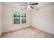 Bedroom featuring neutral carpet, a ceiling fan and a large window with natural light at 306 Teal Ct, Roswell, GA 30076
