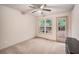 Bright bedroom with neutral carpet, ceiling fan, large window and door to the outside at 306 Teal Ct, Roswell, GA 30076