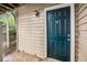 Close-up of unit 306's blue front door with decorative accents and a sidelight at 306 Teal Ct, Roswell, GA 30076