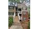 Exterior of condo with a brick facade and wooden stairs leading to second-floor units at 306 Teal Ct, Roswell, GA 30076