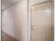 Hallway entrance with a white door, light hardwood floors and neutral walls at 306 Teal Ct, Roswell, GA 30076