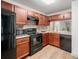 Updated kitchen with stainless steel appliances, mosaic backsplash, and warm wood cabinetry at 306 Teal Ct, Roswell, GA 30076