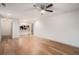 Open living space with hardwood floors, a ceiling fan, and a view into the kitchen area at 306 Teal Ct, Roswell, GA 30076