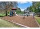 Playground with slides, mulch and various activity centers surrounded by trees at 306 Teal Ct, Roswell, GA 30076