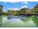 Community tennis courts with blue and green surface and tall netting in a tree-lined setting at 306 Teal Ct, Roswell, GA 30076