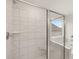 Bathroom featuring a shower with glass door and soaking tub, plus an expansive window at 3760 Near Star Ln, Cumming, GA 30028