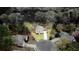An aerial view shows a home nestled amongst trees, with a circular driveway and well-manicured lawn at 540 Basil Sw Ct, Marietta, GA 30064