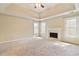 A spacious, carpeted bedroom with a fireplace, tray ceiling, and lots of natural light at 540 Basil Sw Ct, Marietta, GA 30064