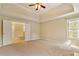 Spacious primary bedroom with carpet floors, tray ceiling, and a private ensuite bathroom at 540 Basil Sw Ct, Marietta, GA 30064