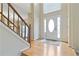 Bright foyer featuring hardwood floors, a staircase, and a front door with side lights at 540 Basil Sw Ct, Marietta, GA 30064