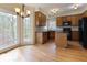 Bright kitchen features a breakfast area, wood cabinets, and an island with black countertops at 540 Basil Sw Ct, Marietta, GA 30064