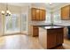 Bright kitchen features a breakfast area, wood cabinets, and an island with black countertops at 540 Basil Sw Ct, Marietta, GA 30064