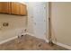 A functional laundry room with overhead cabinets and tile flooring ready to make chores easier at 540 Basil Sw Ct, Marietta, GA 30064