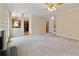 Living room with neutral carpeting, a fireplace, and a view into the kitchen at 540 Basil Sw Ct, Marietta, GA 30064