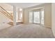 Living room featuring neutral carpet, a staircase, and a large bay window at 540 Basil Sw Ct, Marietta, GA 30064