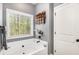 Relaxing primary bathroom suite has a soaking tub and decorative wall art at 95 Hawthorn Ln, Covington, GA 30014