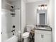Full bathroom features a granite countertop, combination tub and shower, and neutral decor at 95 Hawthorn Ln, Covington, GA 30014