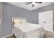 Cozy bedroom features a white bed frame, neutral bedding, and a ceiling fan at 95 Hawthorn Ln, Covington, GA 30014