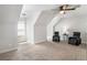 Bonus room featuring vaulted ceilings, carpet, and comfortable seating area at 95 Hawthorn Ln, Covington, GA 30014