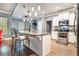 Open kitchen features counter seating, stainless appliances, and stylish pendant lights at 95 Hawthorn Ln, Covington, GA 30014