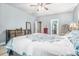 Bright primary bedroom features a ceiling fan and a walk-in closet at 95 Hawthorn Ln, Covington, GA 30014