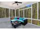 Inviting screened porch features comfortable seating and wooded views at 95 Hawthorn Ln, Covington, GA 30014