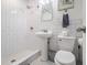 Clean bathroom featuring a pedestal sink, a toilet, and a tiled stand-up shower at 215 Piedmont Ne Ave # 708, Atlanta, GA 30308