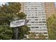View of the Landmark Condominiums building with the sign in front at 215 Piedmont Ne Ave # 708, Atlanta, GA 30308