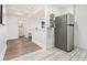 Neutral hallway adjacent to kitchen with hardwood floors and stainless steel refrigerator at 215 Piedmont Ne Ave # 708, Atlanta, GA 30308