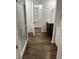 Bright bathroom with sleek fixtures, vanity, walk-in shower, and modern wood-look flooring at 2523 Hood Nw Ave, Atlanta, GA 30318