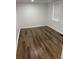 Bedroom features wood-look flooring and a bright window at 2523 Hood Nw Ave, Atlanta, GA 30318