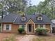 Charming single-story home featuring dormer windows, light-colored shutters and tidy landscaping at 2523 Hood Nw Ave, Atlanta, GA 30318