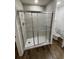 Updated tiled walk-in shower with glass doors and modern fixtures in bright bathroom at 2523 Hood Nw Ave, Atlanta, GA 30318