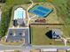 Aerial view of community amenities featuring the pool, clubhouse, tennis courts, and playground at 3780 Near Star Ln, Cumming, GA 30028