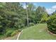 Private backyard with lush greenery and wooded views with a partial fence at 4062 Vinings Mill Se Trl, Smyrna, GA 30080