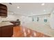 Finished basement with wet bar, mini fridge, hardwood floors, carpet, and multiple windows at 4062 Vinings Mill Se Trl, Smyrna, GA 30080